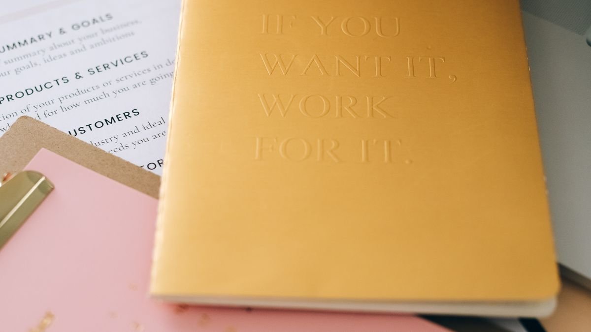 Notebooks and planning materials arranged for building a 12-month career plan