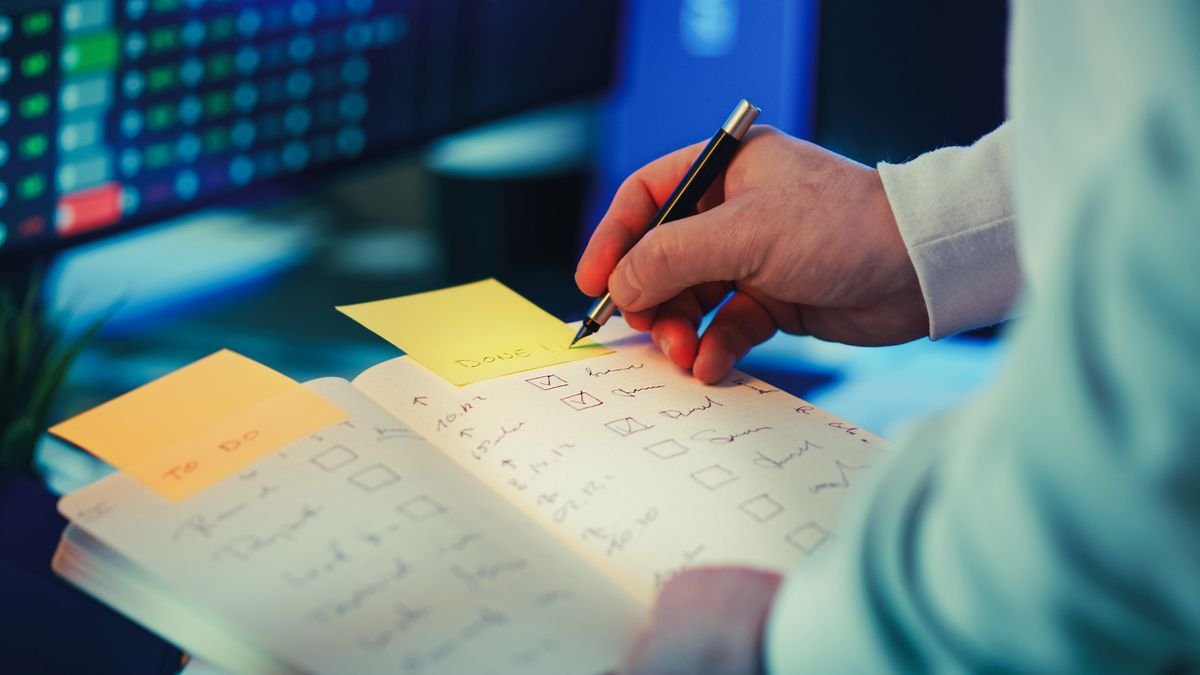 Person using a task checklist to turn career goals into specific actions