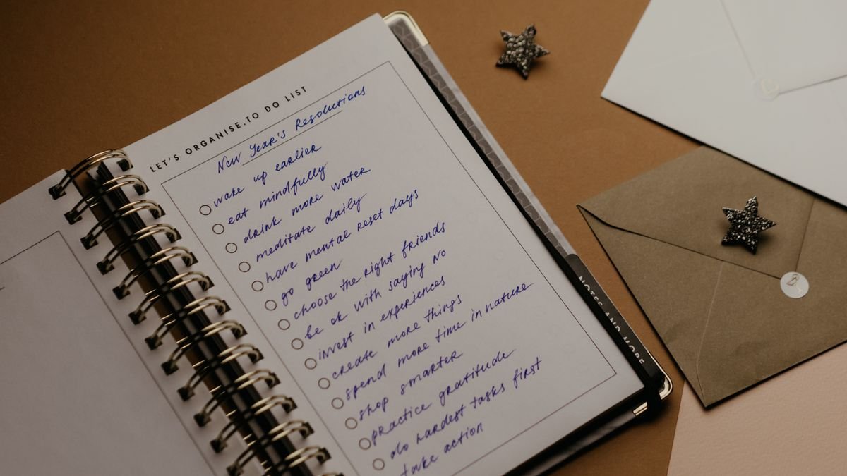 Open planner with handwritten goals for reviewing career progress