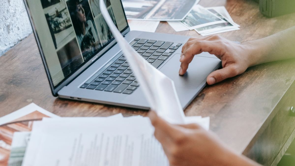 Person reviewing project files and work samples on a laptop