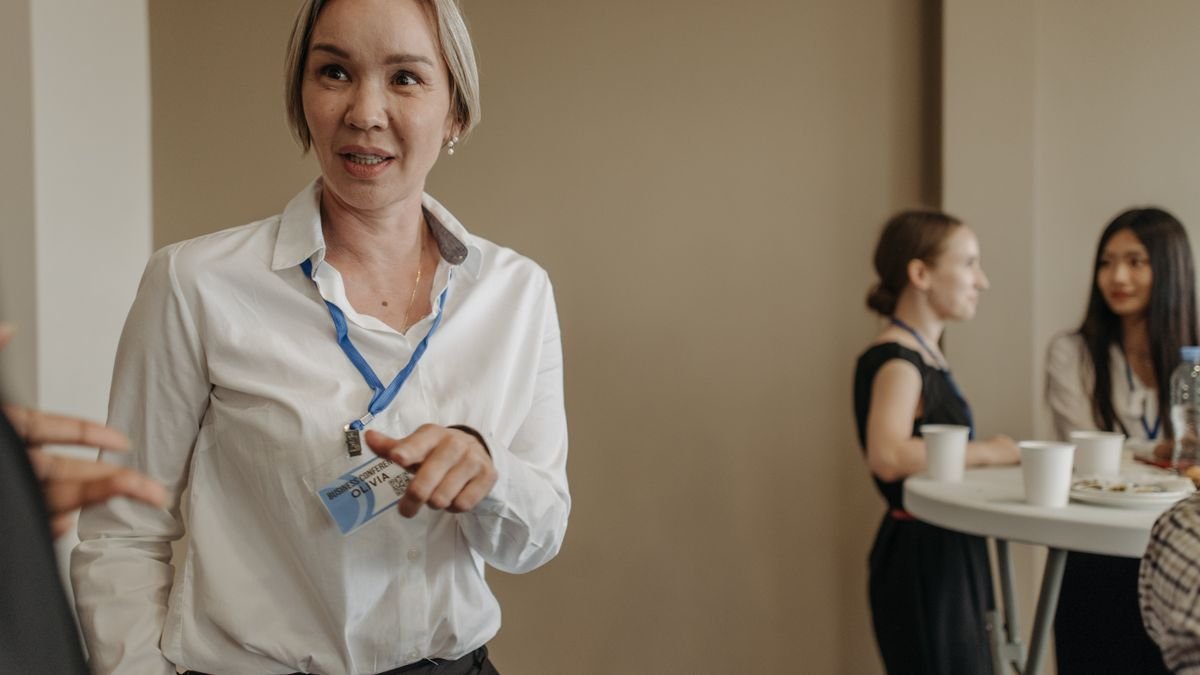 Professional networking event with attendees wearing lanyards and talking