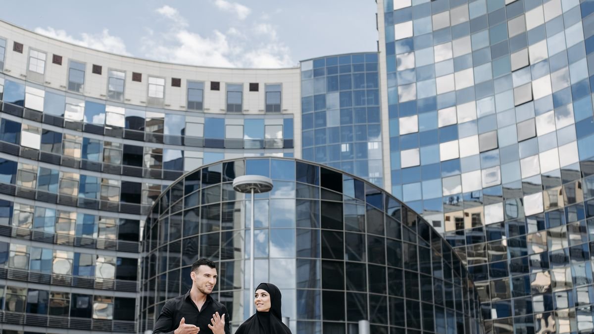 Business professionals having a conversation while walking outside an office building