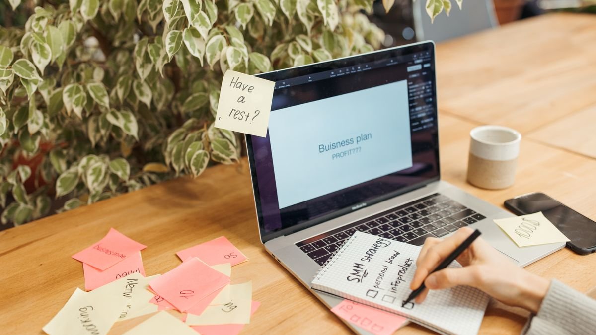 Workspace with sticky notes and a laptop used for career planning
