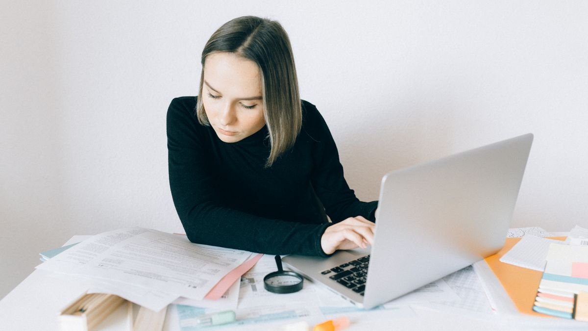 Professional researching career options with a laptop and documents