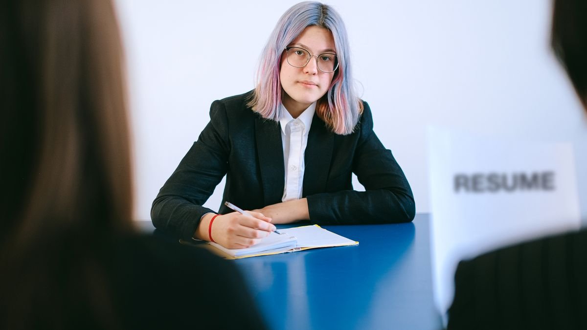Entry-level candidate taking notes during a job interview