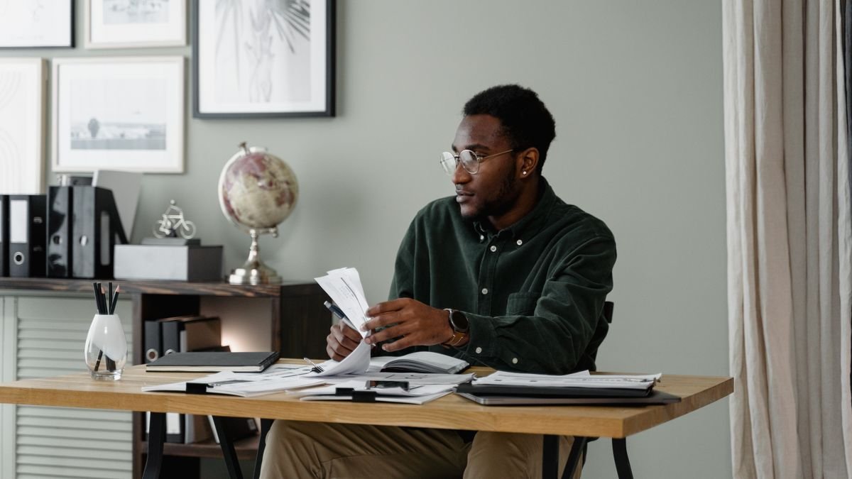 Young professional working with documents and a laptop in an office