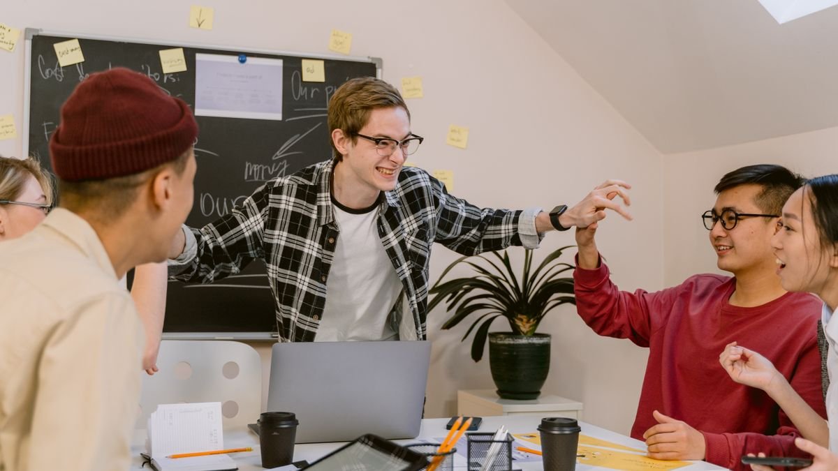 Young professionals collaborating and learning during a team meeting