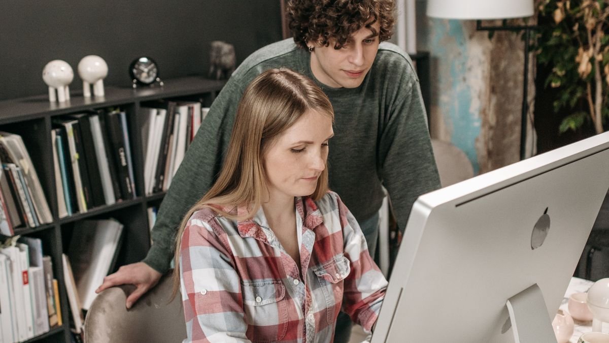Young professionals collaborating at a desk in an office environment