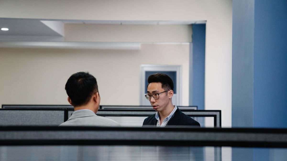 Two professionals having a focused conversation in an office