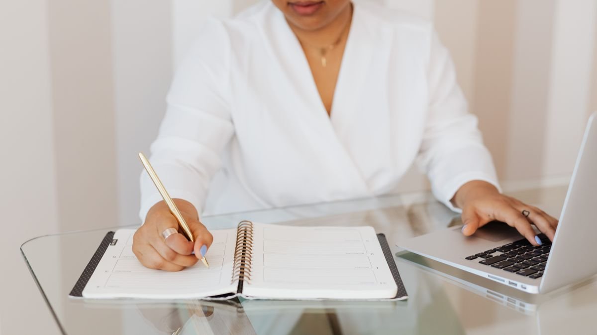 Person reviewing job requirements with a laptop and notebook