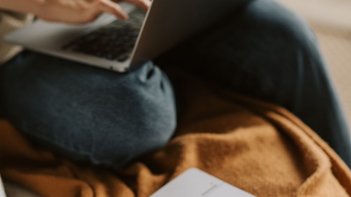 Laptop and planner arranged for reviewing a weekly job search routine