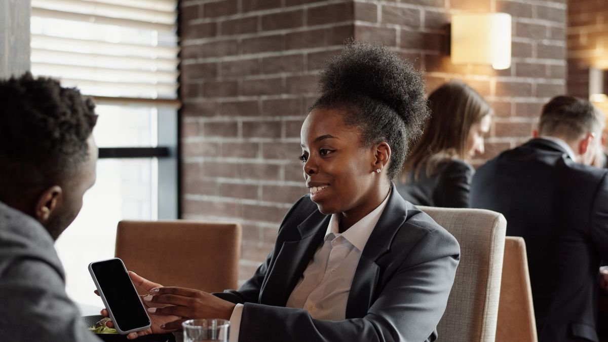 Two professionals talking over coffee while building a professional connection