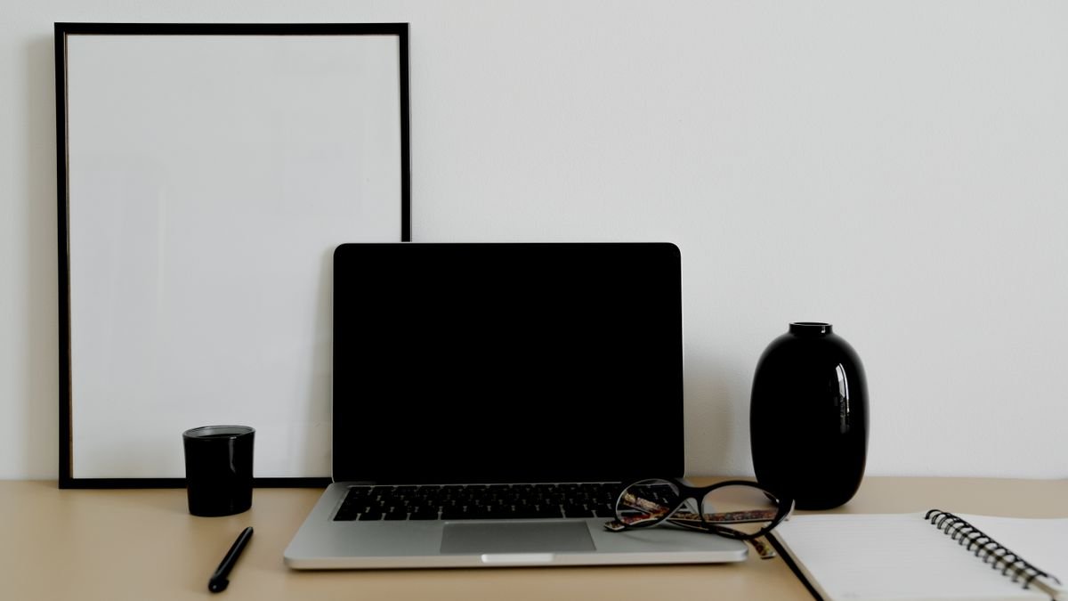 Laptop and notebook on a clean desk for planning resume skills