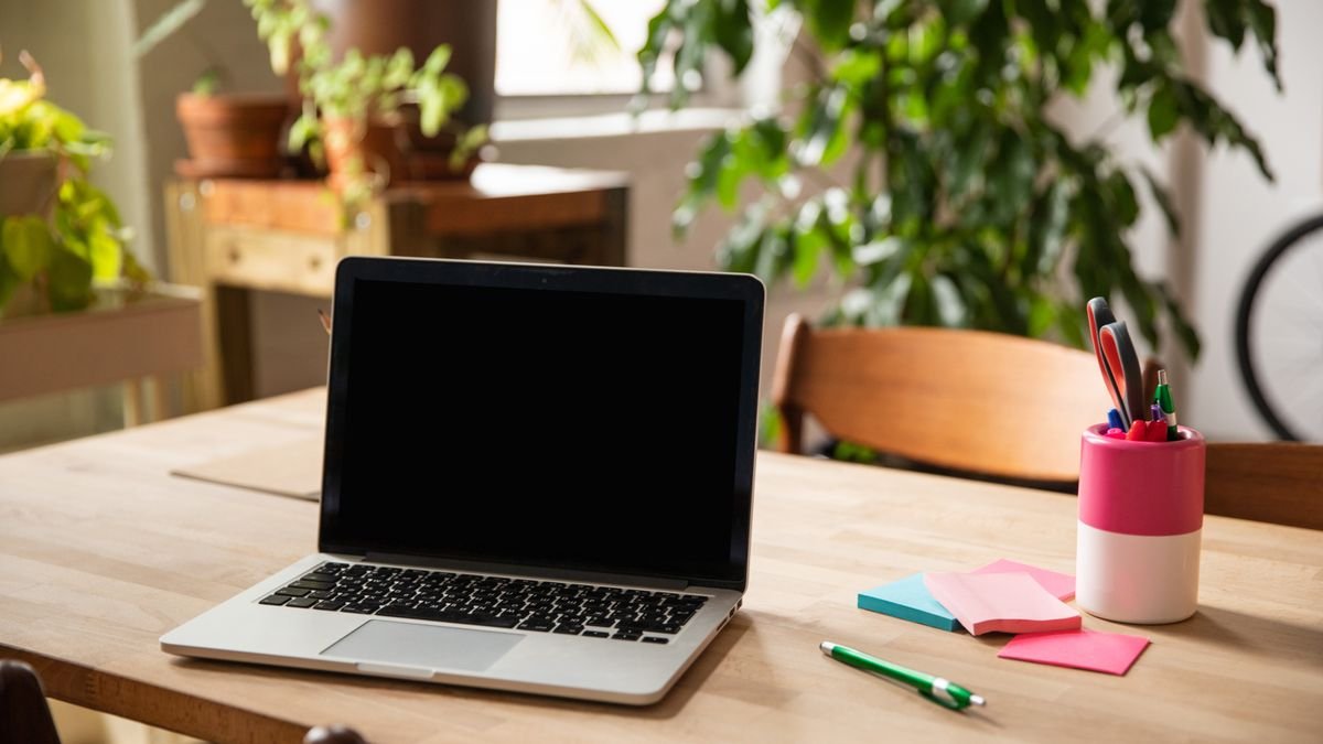 Organized home workspace with laptop and notebooks for practicing job skills