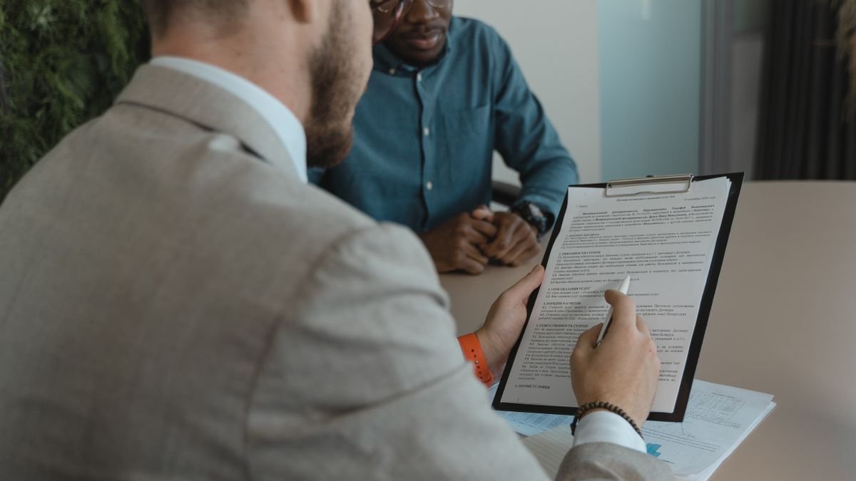 Recruiter reviewing candidate documents during a job interview