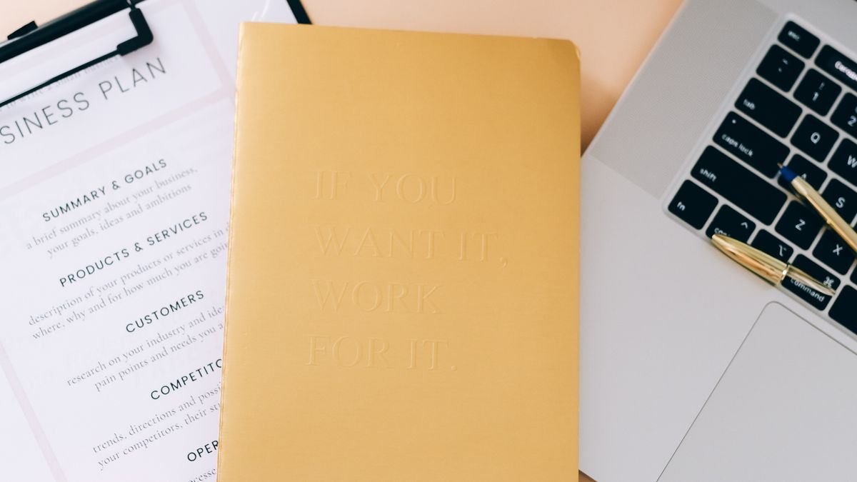 Planner, laptop, and documents arranged for comparing education and training options