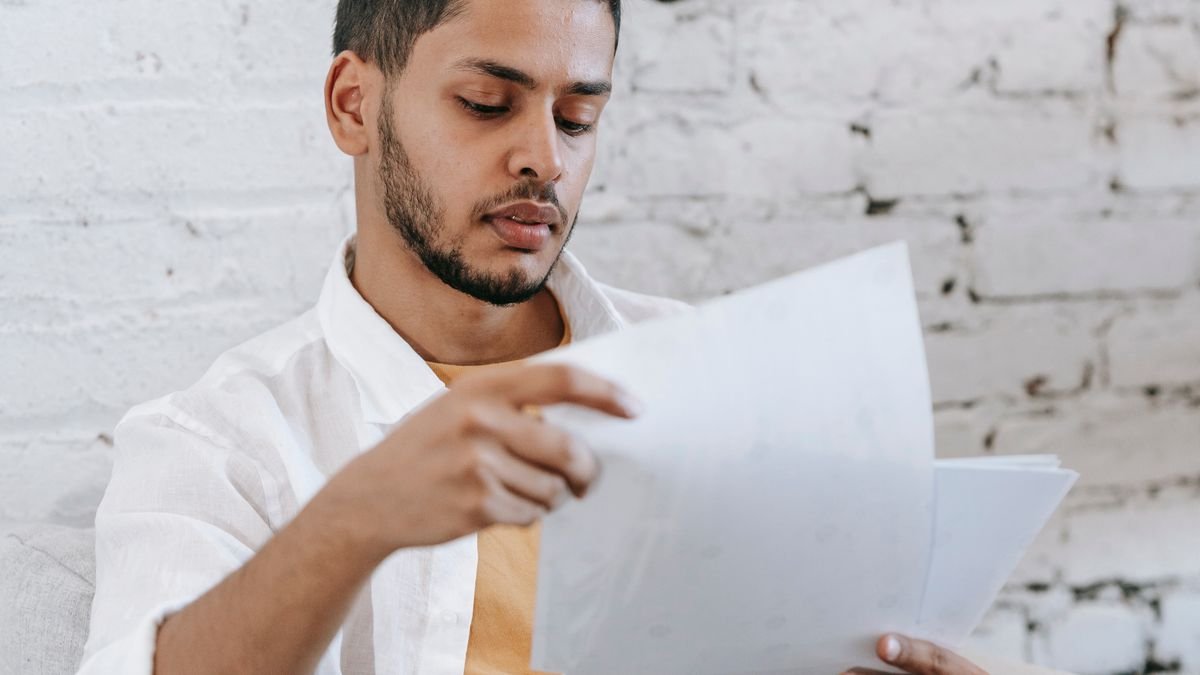 Young professional carefully examining employment documents