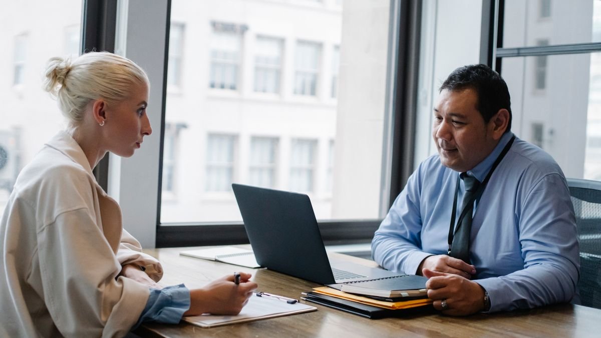 Interviewer speaking with a candidate during a professional job interview